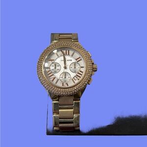 Michael Kors women’s watch in gold and rose gold colour. White face.